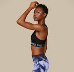 Woman wearing the Move Sports Bra in the color Black