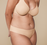 Woman wearing the No-Show Bikini in the color Beige. sizing: Claudia wears size Large