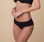 A three quarter angle of model Gracie wearing the No-Show Hiphugger in Black, highlighting the soft stretch and second-skin feel of the fabric.