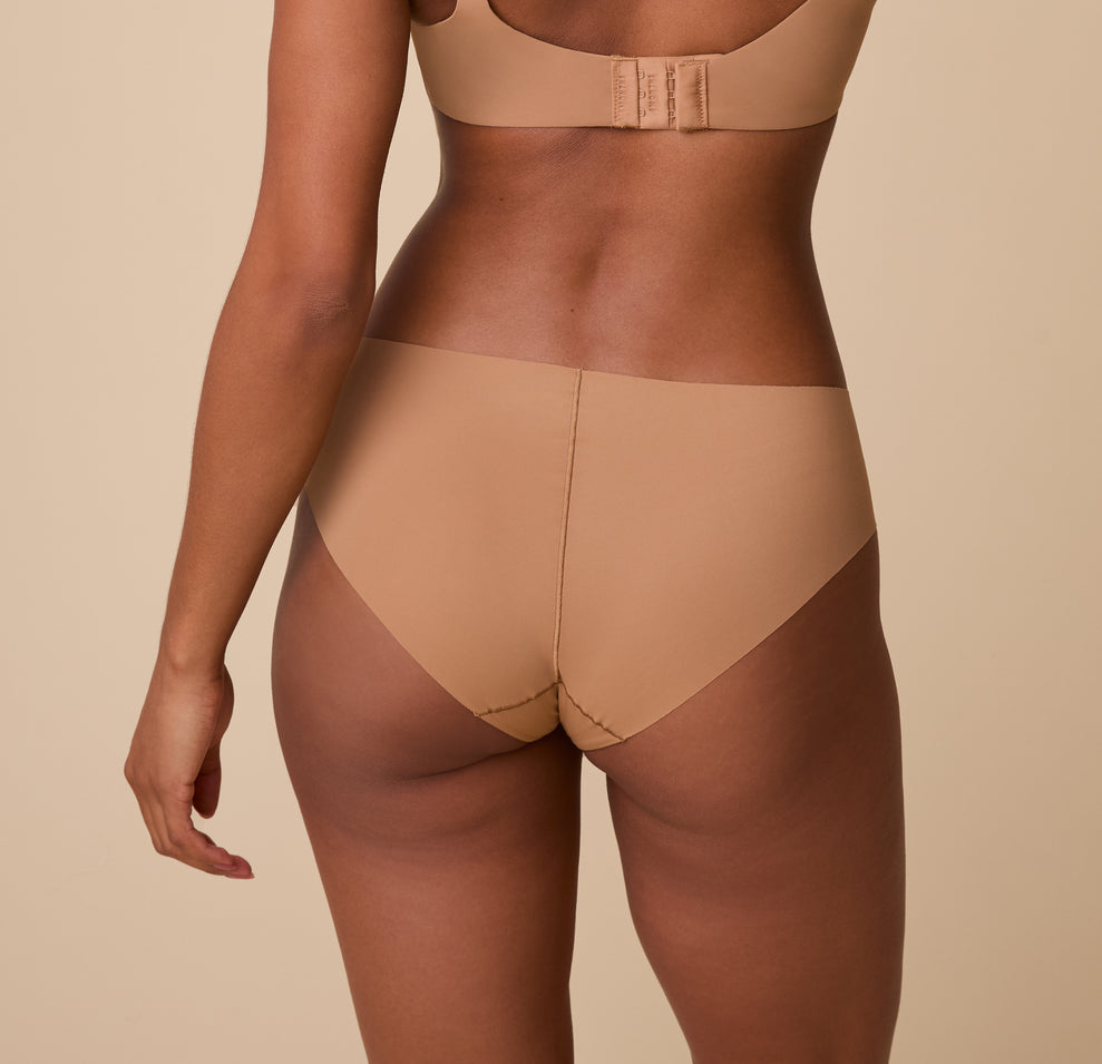 Ally is shown from behind, highlighting the full-coverage back and raw-cut edges for a sleek, no-show finish.
