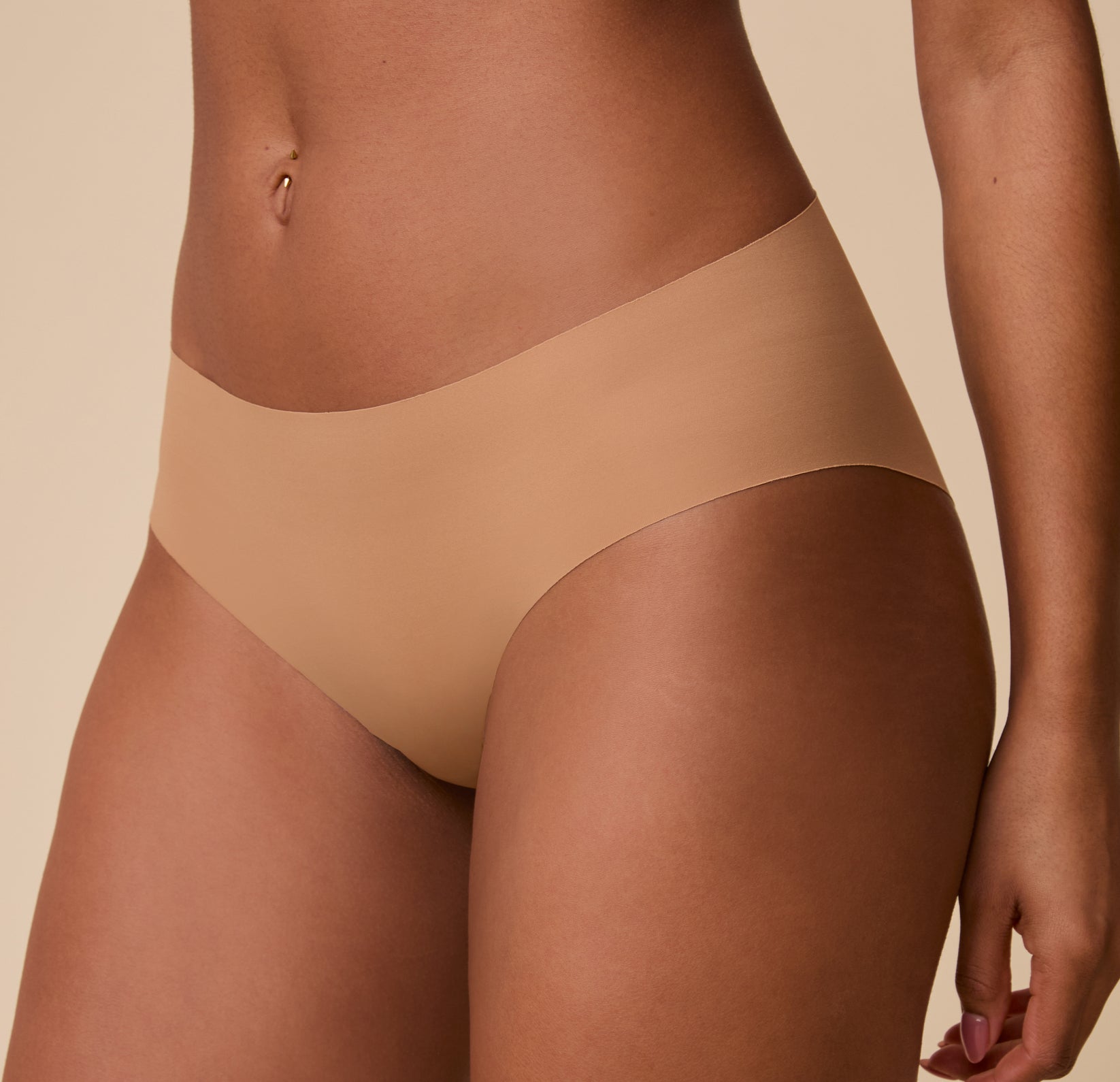 A detailed close-up of the No-Show Hiphugger in Tan, showcasing the ultra-smooth fabric and lightweight, flexible feel.
