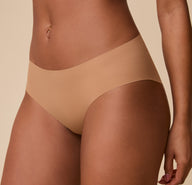 A detailed close-up of the No-Show Hiphugger in Tan, showcasing the ultra-smooth fabric and lightweight, flexible feel.
