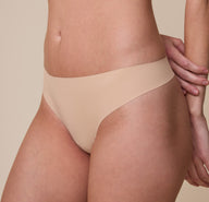 A closer view of the No-Show Thong in Beige, emphasizing the laser-cut edges and smooth, seamless fit for a second-skin feel.