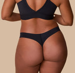 A back view of India in the No-Show Thong in Black, showcasing the minimal coverage and lightweight, no-show design.