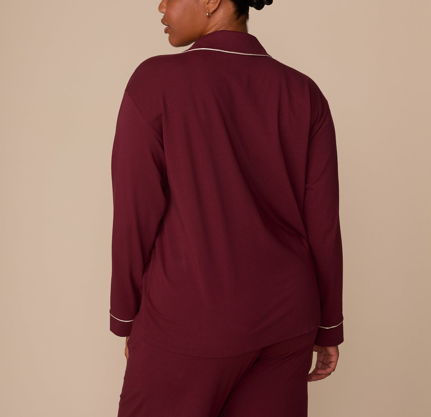 Back view of model Zarria in the Perfect Pima Long Sleeve Pajama Shirt and Pants set in Bordeaux. The image highlights the soft drape and relaxed fit of the fabric.