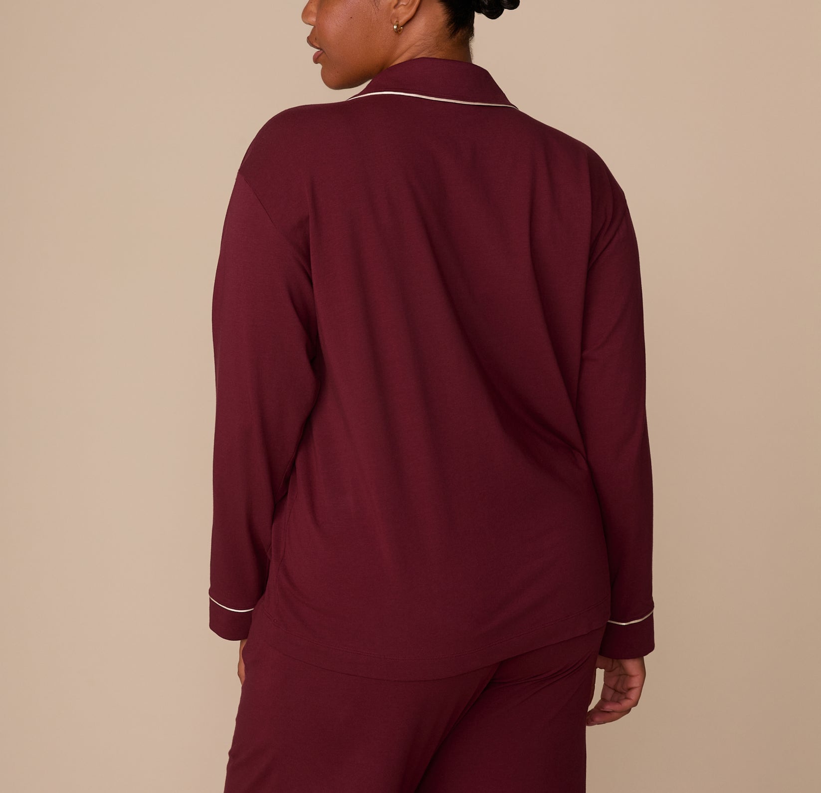 Back view of model Zarria in the Perfect Pima Long Sleeve Pajama Shirt and Pants set in Bordeaux. The image highlights the soft drape and relaxed fit of the fabric.