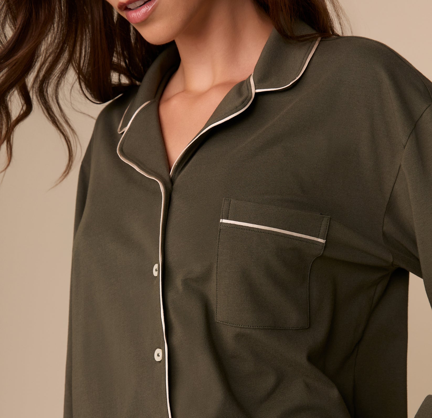 Close-up of the chest pocket and collar on the Perfect Pima Long Sleeve Pajama Shirt in Olive. White piping outlines the collar and pocket opening.