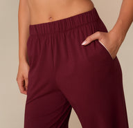 Close-up of the side pocket and waistband of the Perfect Pima Pajama Pants in Bordeaux. White piping lines the pocket opening.