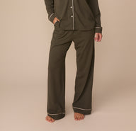 Cropped front view of Alexis wearing the Perfect Pima Pajama Pants in Olive with the matching Perfect Pima Long Sleeve Pajama Shirt. The image focuses on the wide-leg cut and contrast piping at the cuffs.