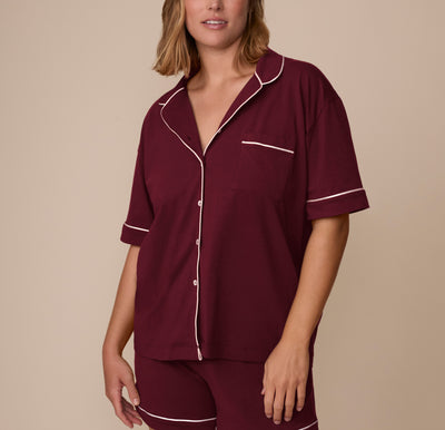 Front view of model Sonnie wearing the Perfect Pima Pajama Shirt and Shorts in Bordeaux. The button-down shirt features white contrast piping along the collar, sleeves, and chest pocket. sizing: Sonnie wears size Large