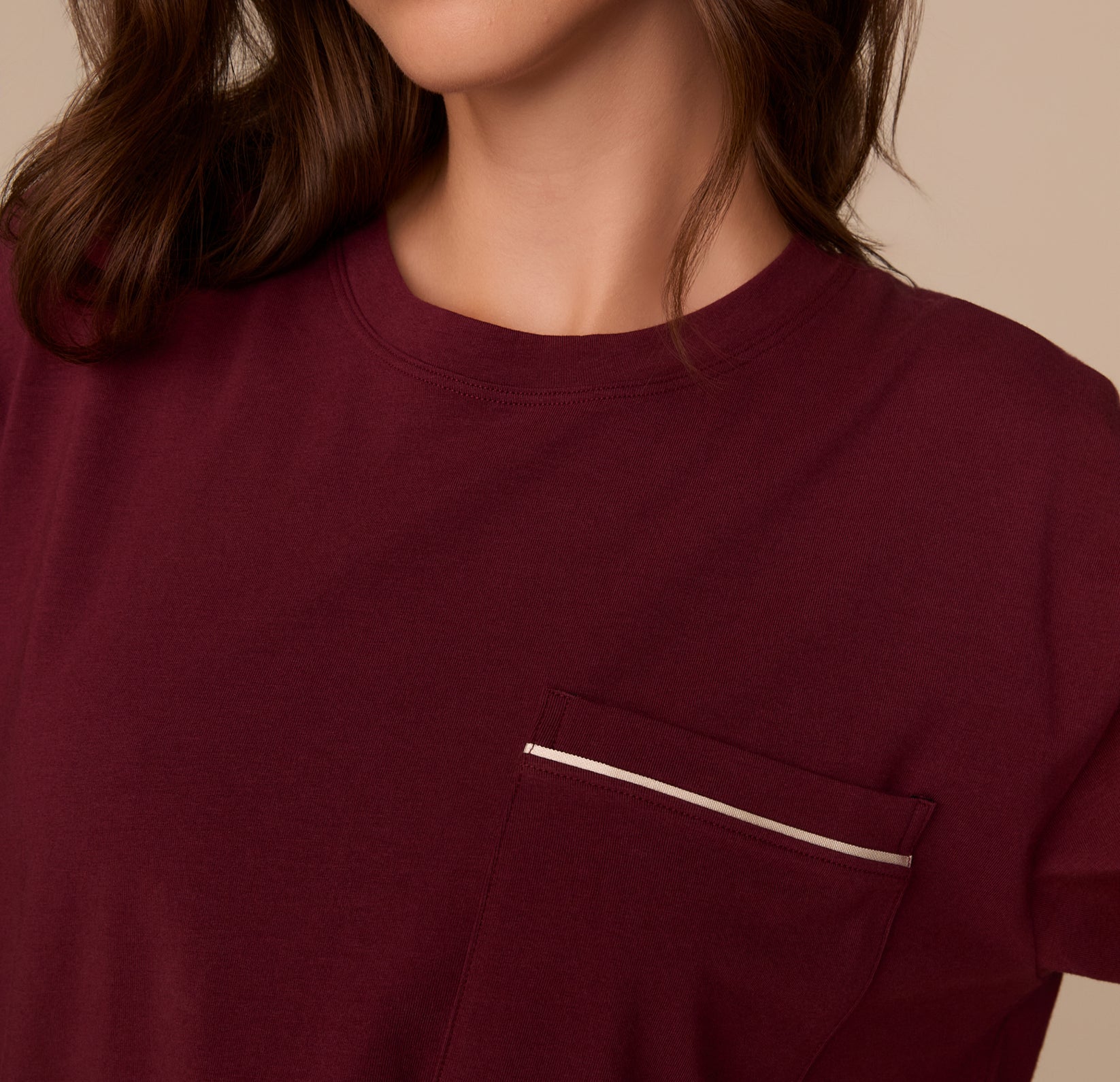 Close-up of the chest pocket on the Perfect Pima Pajama Tee in Bordeaux, highlighting the white contrast piping detail.