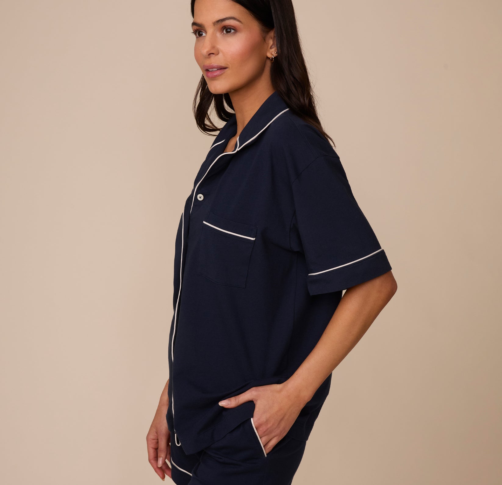 Side profile of Marcela wearing the Perfect Pima Pajama Shirt in Navy with her hand in the matching Perfect Pima Pajama Shorts pocket, emphasizing the casual, comfortable fit.