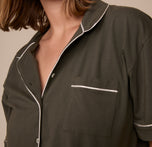 Close-up of the Perfect Pima Pajama Shirt in Olive, focusing on the chest pocket and contrast white piping trim, with the collar slightly open for a relaxed look.