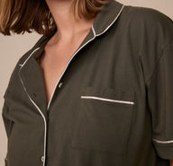 Close-up of the Perfect Pima Pajama Shirt in Olive, focusing on the chest pocket and contrast white piping trim, with the collar slightly open for a relaxed look.
