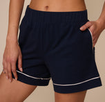 Close-up of the waistband and pocket area of the Perfect Pima Pajama Shorts in Navy, emphasizing the soft stretch fabric and tailored white piping trim.