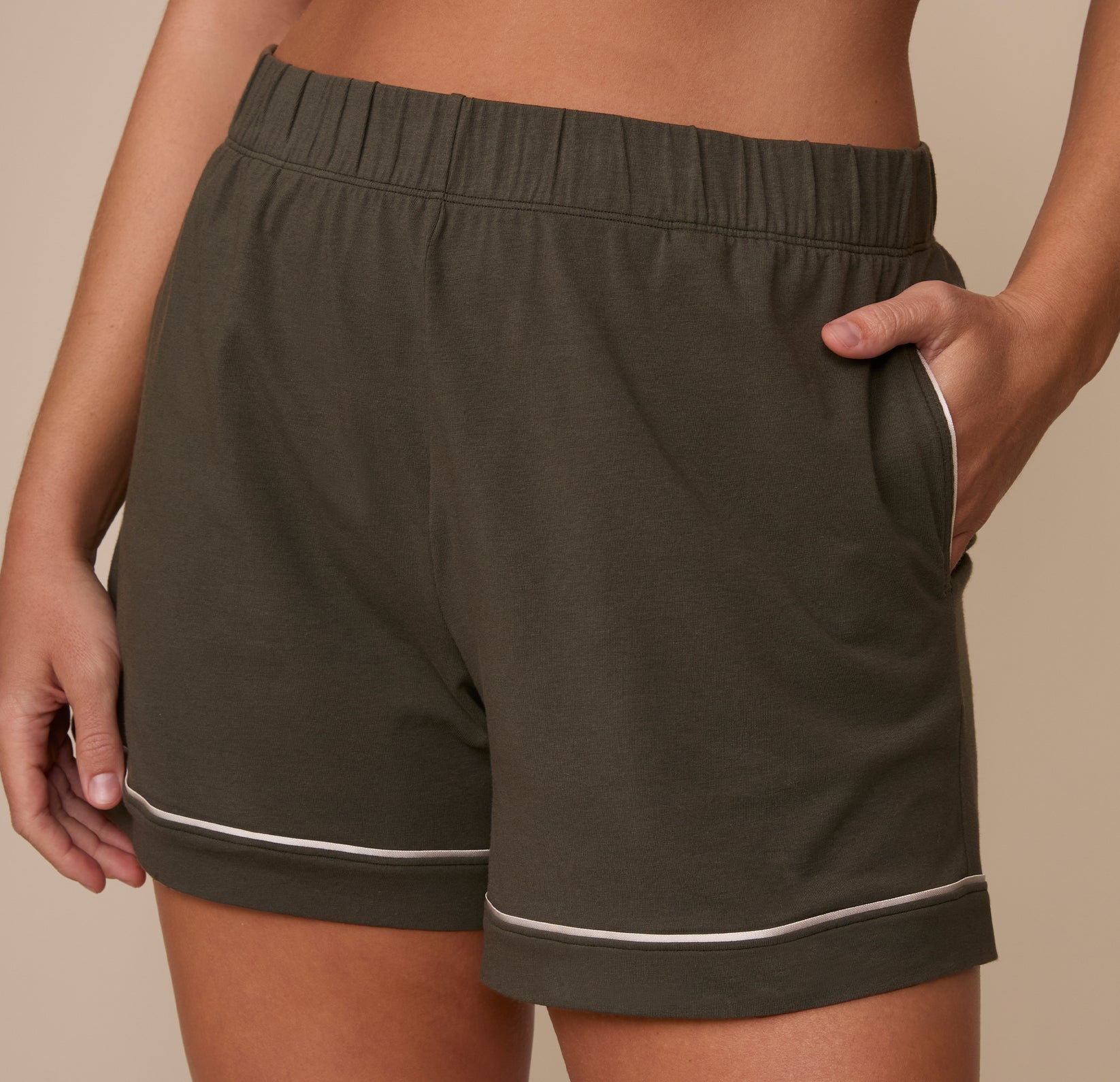 Close-up of the Perfect Pima Pajama Shorts in Olive focusing on the soft waistband and white trim on the pockets and hem.