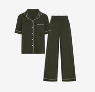 Harper Wilde Pima Pajama Set in Olive. Includes short sleeve, button-up top with white piping and matching long pajama pants. Set laid flat on a white background.