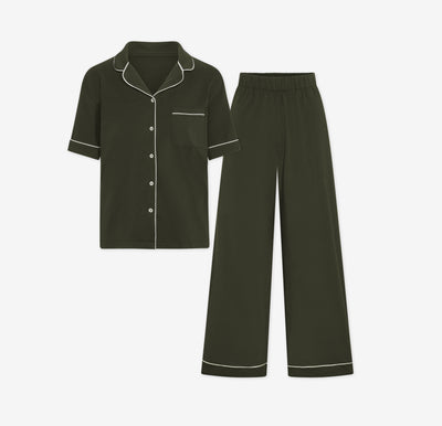 Harper Wilde Pima Pajama Set in Olive. Includes short sleeve, button-up top with white piping and matching long pajama pants. Set laid flat on a white background.