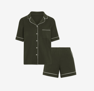 Harper Wilde Pima Pajama Set in Olive. Includes short sleeve, button-up top with white piping and matching pajama shorts. Set laid flat on a white background.