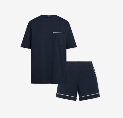 Harper Wilde Pima Pajama Set in Navy. Includes relaxed fit tee with white chest pocket piping and matching pajama shorts. Set laid flat on a white background.