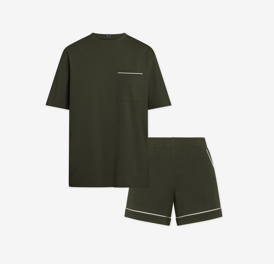 Harper Wilde Pima Pajama Set in Olive. Includes relaxed fit tee with white chest pocket piping and matching pajama shorts. Set laid flat on a white background.