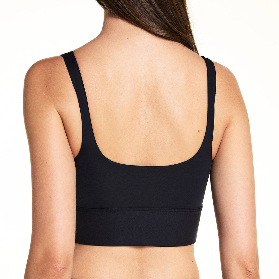 Back view of model wearing the Bliss Squareneck Bralette in Black, showing the clean wide-strap back and thick underband.
