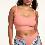 Front view of model wearing the Bliss Squareneck Bralette and matching high-waist underwear in Cabana, with unfastened light wash denim jeans.