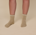 Close up of a model wearing the Quarter Crew Socks in the color Tarragon..