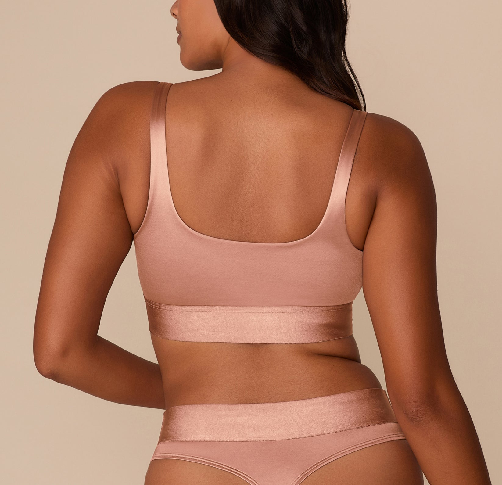 Side view of Victoria in the Stretch Satin Square Neck Bralette in Champagne, highlighting the structured silhouette and shine of the stretch satin fabric.
