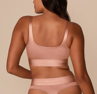 Side view of Victoria in the Stretch Satin Square Neck Bralette in Champagne, highlighting the structured silhouette and shine of the stretch satin fabric.