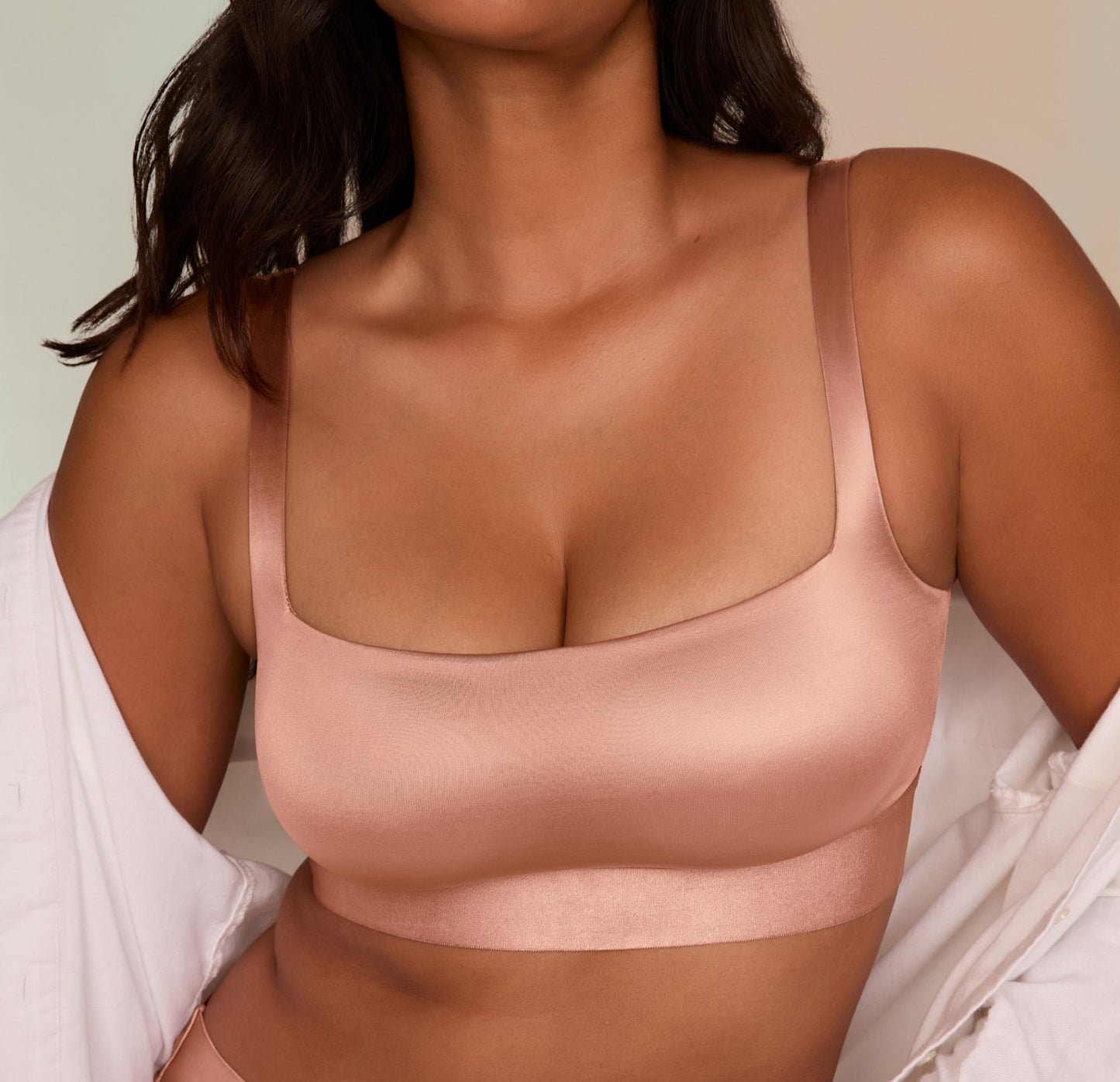 Victoria wearing the Stretch Satin Square Neck Bralette in Champagne with an unbuttoned shirt layered over it, styled for a lounge-inspired look.