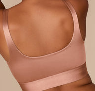 Rear view of Victoria in the Stretch Satin Square Neck Bralette in Champagne, displaying the straight-cut back and secure, wide band fit.