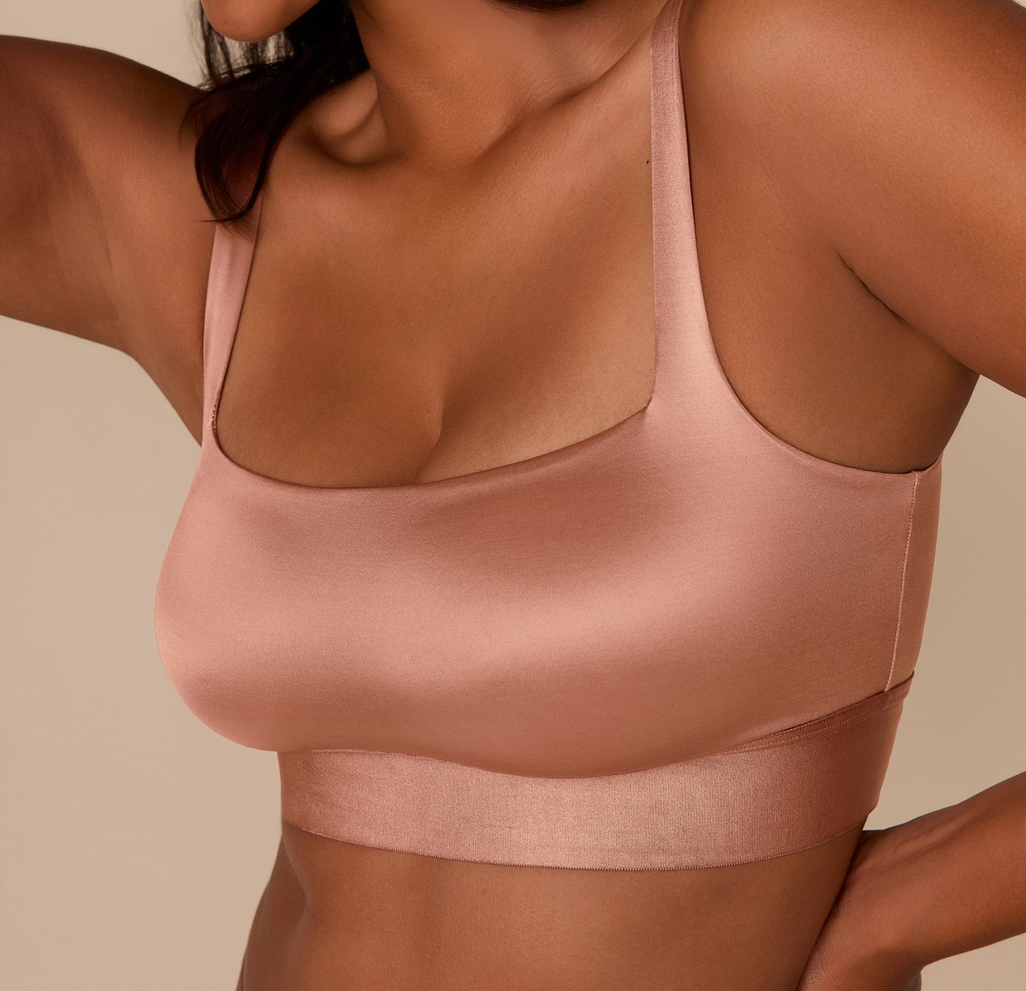 Up close shot of Victoria in the Stretch Satin Square Neck Bralette in Champagne, softly lit to highlight the smooth texture and supportive shape of the bralette.