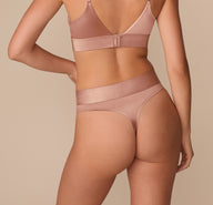 Back view of Alexis in the Stretch Satin Highwaist Thong in Champagne, showing the thong cut and high-rise fit with a soft sheen.