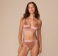 Full front view of Alexis in the Stretch Satin Highwaist Thong and Triangle Bralette in Champagne, standing with a relaxed expression and confident stance.
