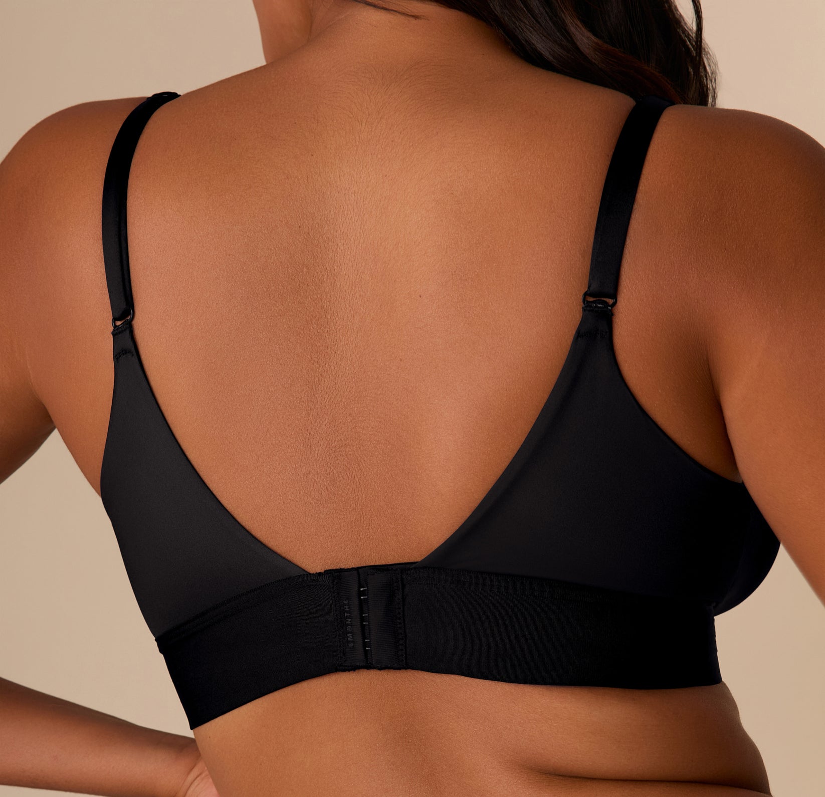 Close-up of the back of the Stretch Satin Triangle Bralette in Black, highlighting the soft stretch satin fabric, adjustable straps, and secure hook closure.