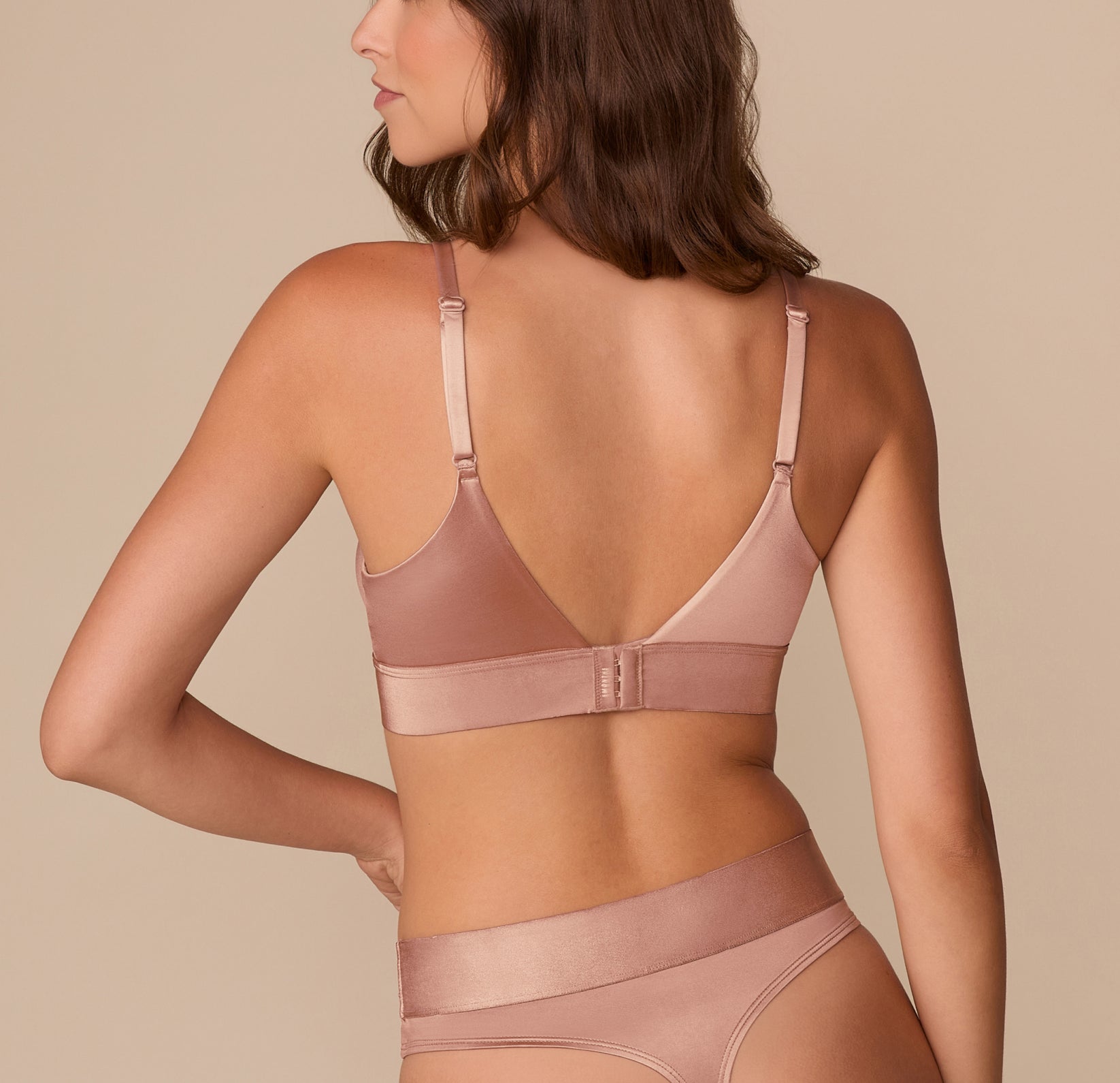 Back view of Alexis in the Stretch Satin Triangle Bralette in Champagne, showcasing adjustable straps and a wide satin band with a hook-and-eye closure.