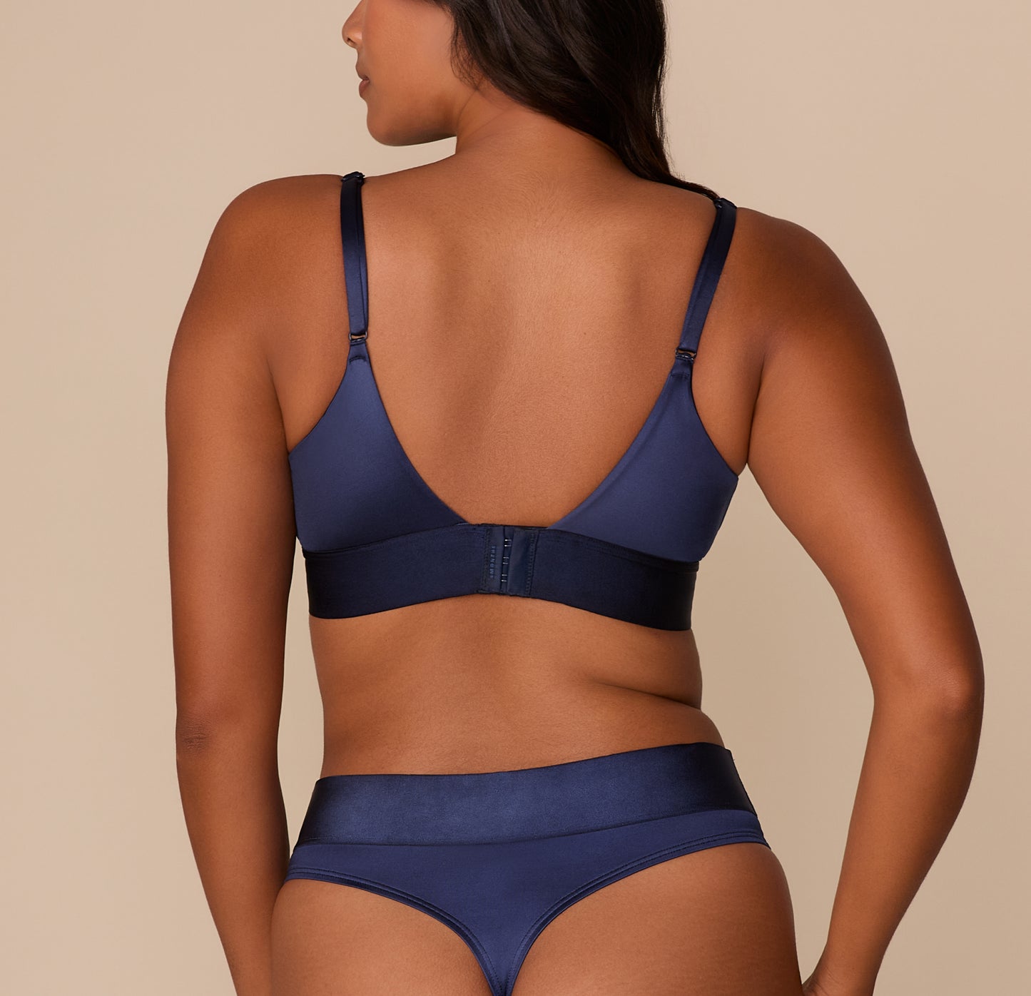Back view showing adjustable straps and hook-and-eye closure on the Stretch Satin Triangle Bralette in Navy.
