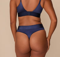 Rear view of the Navy Highwaist Thong, showcasing minimal coverage and smooth satin finish.