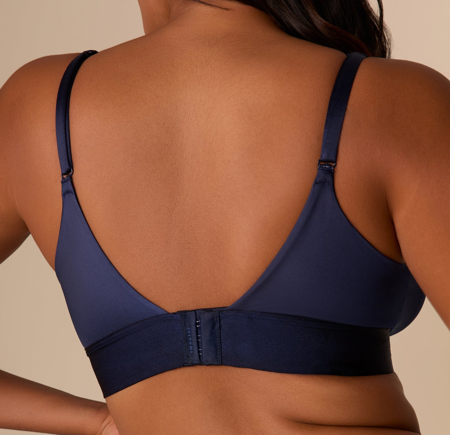 Back close-up of the bralette’s band and strap detailing in Navy. The adjustable straps and hook and eye back are emphasized.