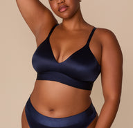 Zarria wearing the Stretch Satin Triangle Bralette in Navy, paired with the matching Highwaist Thong, showcasing a curve-inclusive fit. sizing: Zarria wears size XL