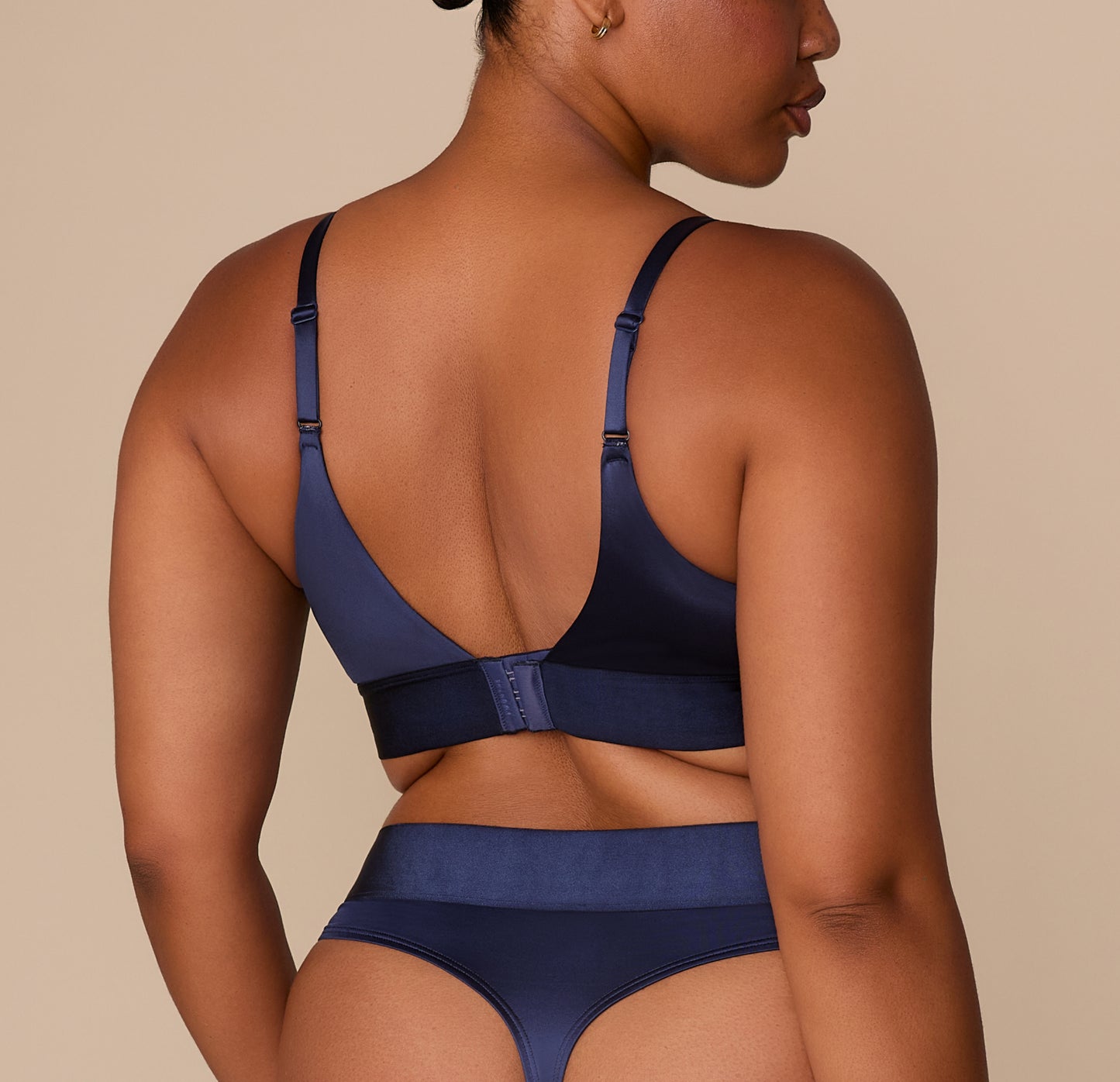 Back view of Zarria in the Navy Triangle Bralette, showing strap adjustability and wide satin band.