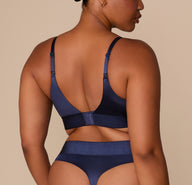 Back view of Zarria in the Navy Triangle Bralette, showing strap adjustability and wide satin band.