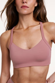 In a close-up studio shot, Gianna wears the Whipped Knit V-Neck Bralette in Plum, highlighting the V-neckline, textured knit fabric, and wide straps designed for comfortable support. sizing: Gianna wears size Small