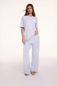 In a studio setting, Linni wears the Perfect Pima Pajama Tee in Soft Blue with matching pants, featuring a relaxed fit, crew neckline, and short sleeves.