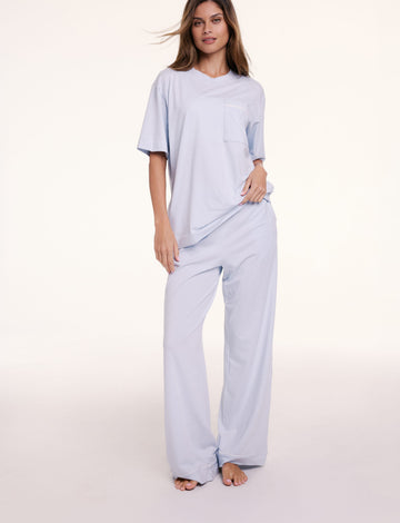 In a studio setting, Linni wears the Perfect Pima Pajama Tee in Soft Blue with matching pants, featuring a relaxed fit, crew neckline, and short sleeves.