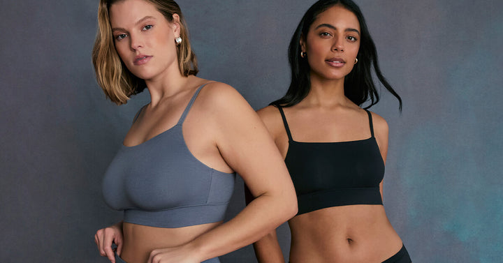 Two models wearing the Cloud Cotton Thin Strap Bralette—one in Slate, the other in Black. The image highlights the minimalist design, ultra-soft cotton fabric, and thin shoulder straps.