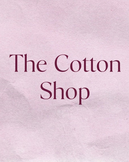 Blush pink crumpled paper background with text that reads "The Cotton Shop"