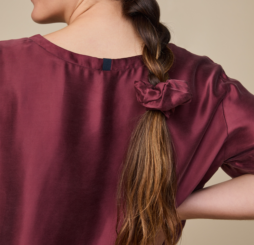 Model wearing the Silky Sleep T-Shirt in the color Sangria.