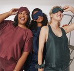 Three models wearing the Silky Sleep Pajama collection in the colors Sangria, Midnight and Forest.